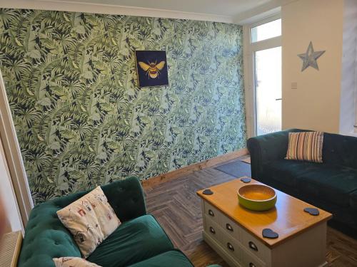 a living room with a couch and a table at Eden Rose Cottage hot-tub jacuzzi morecambe-bay in Morecambe