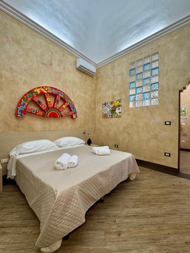 a bedroom with a large bed with towels on it at Summer Wind Apartments in Trapani