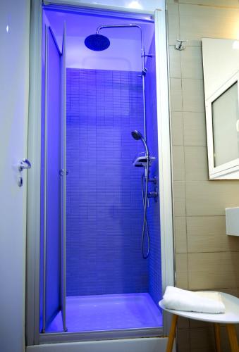 a bathroom with a shower with blue glass at Finestra sui Ponti in Ragusa