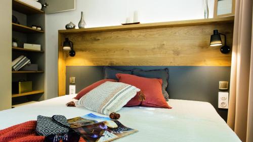 a bedroom with a bed with a wooden headboard at Camping-Village del Sole in Cannobio