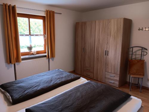 a bedroom with a bed and a wooden cabinet at Ferienwohnung Butterfly in Lam
