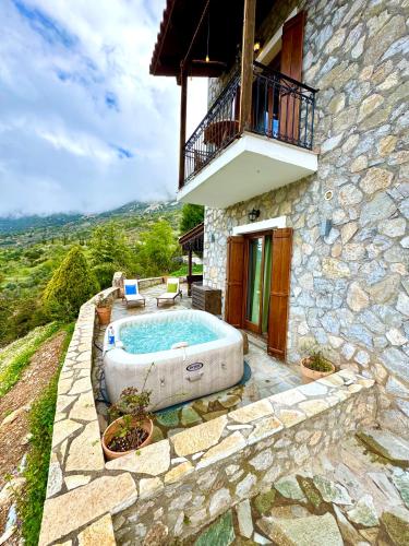 a building with a large bath tub in a yard at Rock Dandy Deluxe Chalet in Arachova - Delphi, Sauna, Prv Parking, Amazing View in Arachova