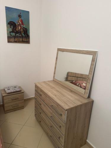 a mirror on top of a dresser in a room at Heart of Vlora Apartment in Vlorë