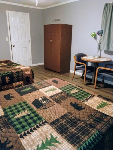 a bedroom with a bed and a table and a rug at Sandy's House in Minden