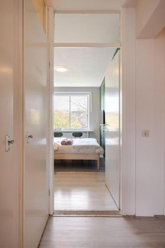 a door leading to a bedroom with a bed at Amsterdam Centraal in 10 minutes - nearby metro in Amsterdam