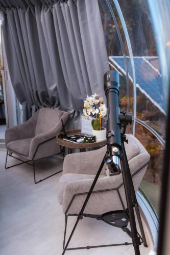 a camera in a room with two chairs and a table at The Star Dome, Thunzi Bush Lodge in Beach View