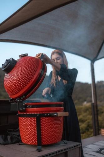a woman is standing next to a red chair at The Star Dome, Thunzi Bush Lodge in Beach View