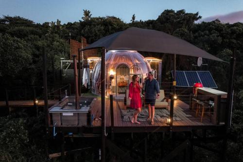a couple standing on the deck of a boat at The Star Dome, Thunzi Bush Lodge in Beach View