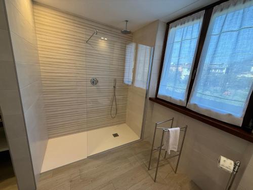 a bathroom with a shower with a glass door at Casa Martinelli in Nago-Torbole