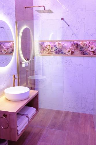 a bathroom with a sink and a mirror at Story Rooms in Olomouc