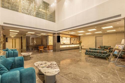 a lobby with blue couches and chairs and tables at Sterling Borderland Amritsar in Amritsar