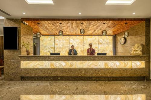 two men standing at a counter in a lobby at Sterling Borderland Amritsar in Amritsar