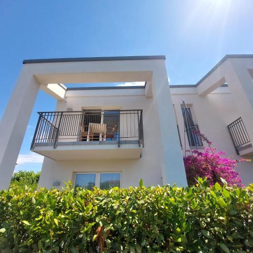 a building with a balcony with a table and chairs on it at Slowersilia Bed and Breakfast in Lido di Camaiore