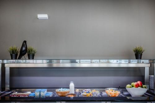 a counter with some food on a shelf at Hotel Corsendonk Viane in Turnhout