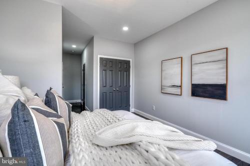 a bedroom with a bed and two pictures on the wall at High level Where Sophistication meets Elegance in Baltimore