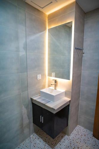 a bathroom with a sink and a mirror at HaiVen Angkor Residence & Hotel in Siem Reap