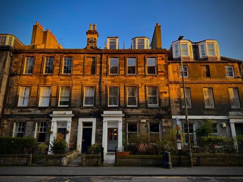 a large brick building on a city street at The Valentine - Townhouse Hotel - Adults Only in Edinburgh