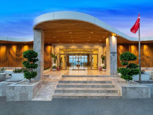 a lobby of a building with a red flag at Swissôtel Living Bodrum in Bodrum City