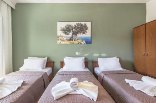 a bedroom with two beds with a bow on them at Galini apartments Polyhrono in Kassandria