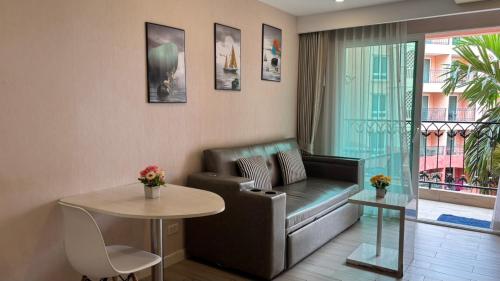 a living room with a couch and a table at seven sea F508 in Jomtien Beach