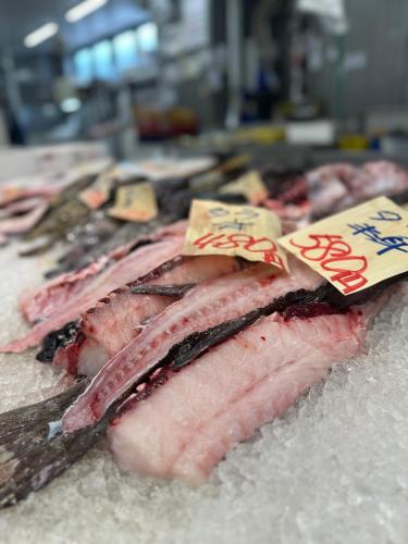 a pile of meat on a counter with signs on it at ZABOCON YOICHI Villa in Yoichi