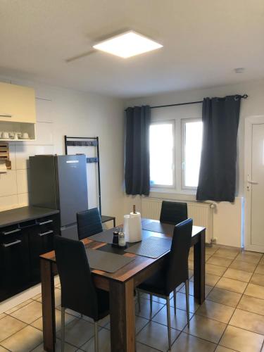 a kitchen with a table and chairs in a room at Schaaf in Roth