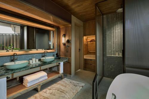 a bathroom with two sinks and a shower at Mandai Rainforest Resort by Banyan Tree in Singapore