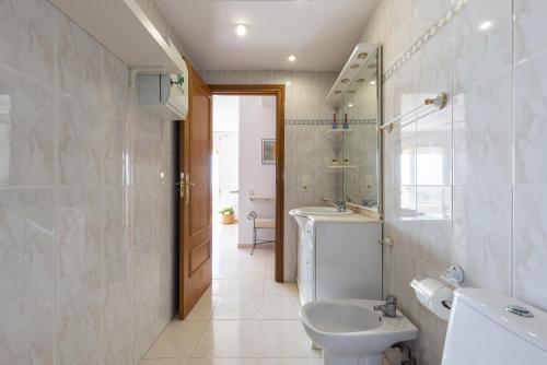 a bathroom with a sink and a toilet and a mirror at Apartamento Mare Internum I in La Pineda