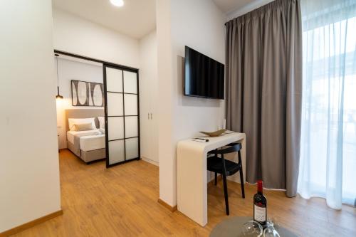 a hotel room with a table and a bed at Iaspis Luxury Suites in Bendevís