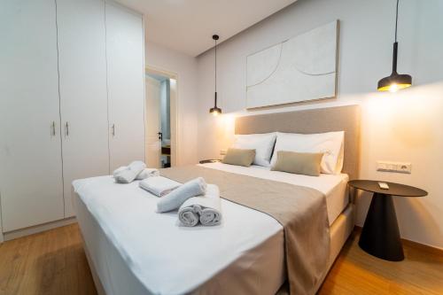 a bedroom with two beds with towels on the bed at Iaspis Luxury Suites in Bendevís