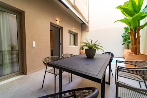 a dining room with a table and chairs at Iaspis Luxury Suites in Bendevís