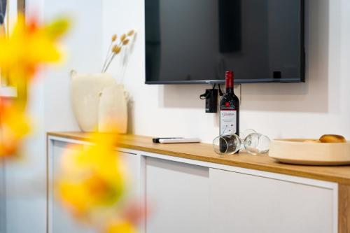 a bottle of wine sitting on top of a counter at Iaspis Luxury Suites in Bendevís