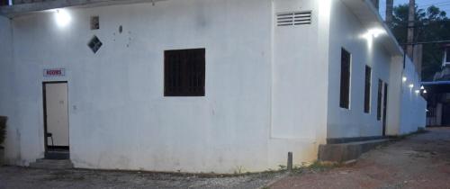 a white building with a door and a window at Black Rose Guest in Gampaha