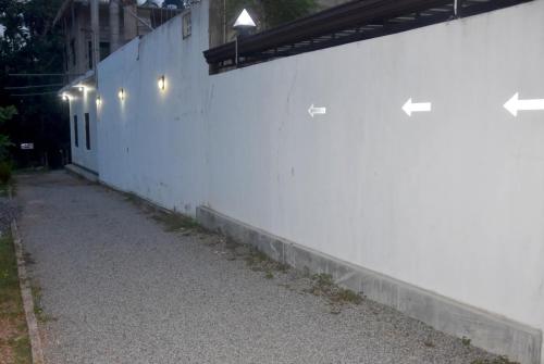 a white wall with lights on the side of it at Black Rose Guest in Gampaha