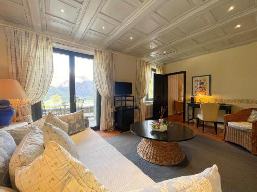 a living room with a couch and a table at Ristorante della Stazione da YanElo in Intragna