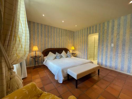 a bedroom with a bed and a chair in it at Ristorante della Stazione da YanElo in Intragna