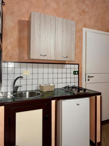 a kitchen with a sink and a counter top at Summer Wind Apartments in Trapani
