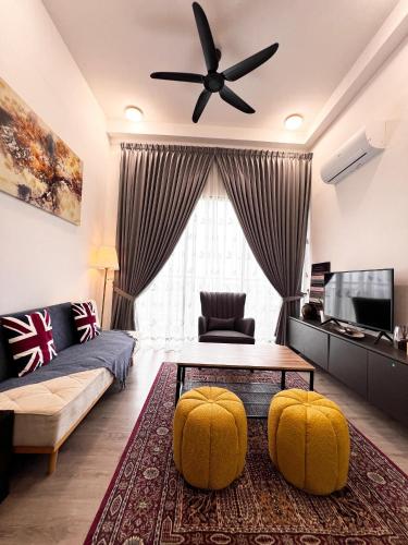 a living room with a couch and a ceiling fan at MySky Stays Putrajaya in Putrajaya