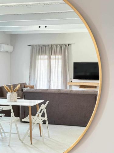 a mirror in a living room with a couch and a table at Horizon Seaview Apartments II in Lassi