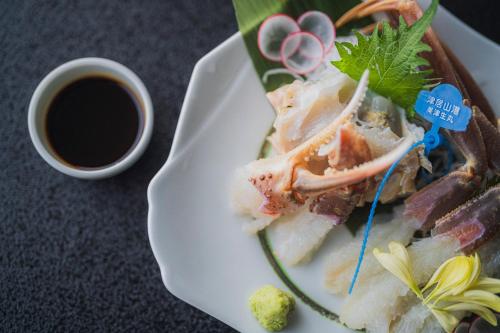 a plate of food with seafood and a cup of coffee at Shinzan Kinosaki in Toyooka