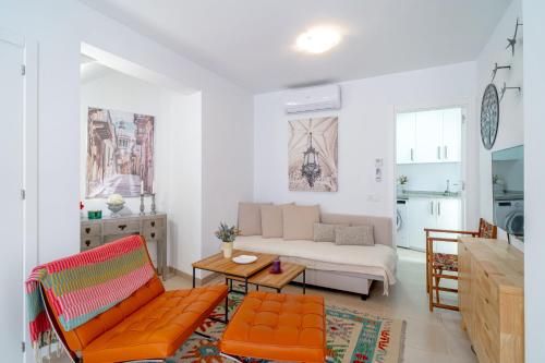 a living room with a couch and a table at Casa Alegre by Casasol in Nerja