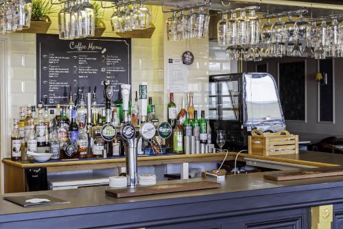 a bar with a lot of bottles of alcohol at The Majestic Hotel in Eastbourne