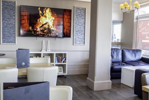a living room with a couch and a fireplace at The Majestic Hotel in Eastbourne