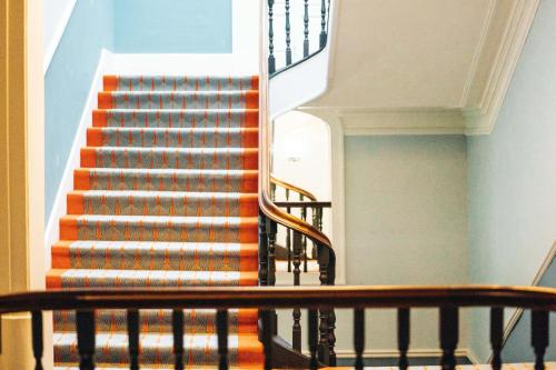 a staircase with an orange and white stair case at GRANDE HOTEL PARIS by STAY HOTELS in Porto