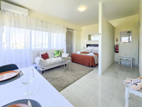 a living room with a couch and a bed at Alvor Studio Land & Sea View in Alvor