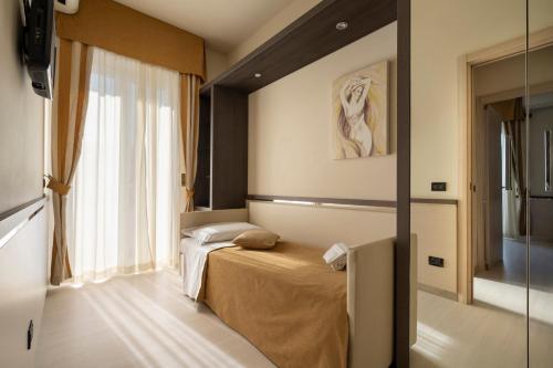 Ένα ή περισσότερα κρεβάτια σε δωμάτιο στο Hotel Mondial