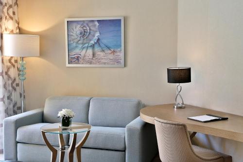 a living room with a couch and a table at Hilton Hurghada Plaza Hotel in Hurghada