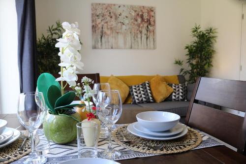 a dining room table with plates and glasses on it at Castle Park House in Stafford