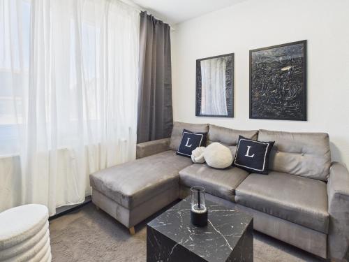 a living room with a couch and a table at Loft & Living 3 am Geiseltalsee WLAN & Parkplatz in Braunsbedra