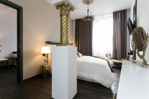 a hotel room with a bed and a mirror at Aparthotel Dei Mercanti in Milan